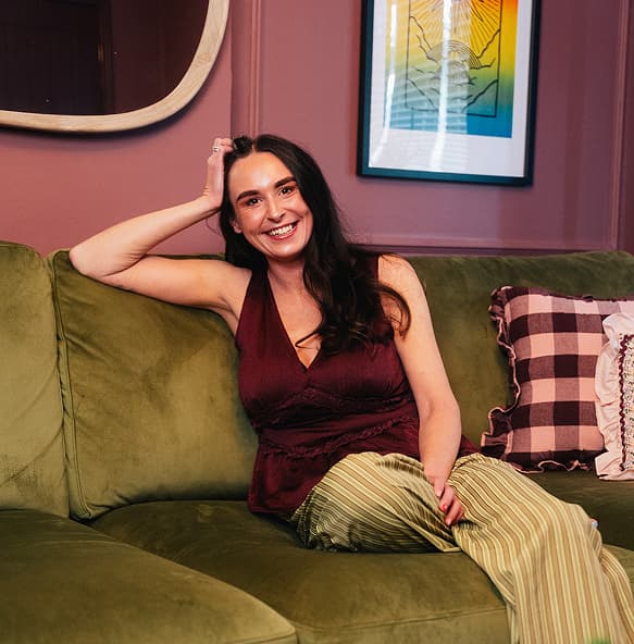 Rebecca sat on sofa
