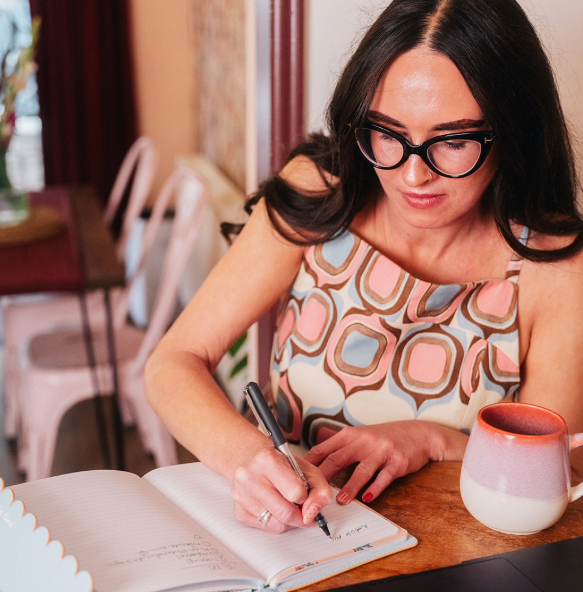 Rebecca writing in notebook